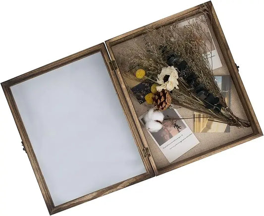 Open wood shadow box frame with hinged tempered glass door showing linen back panel and preserved bouquet keepsakes